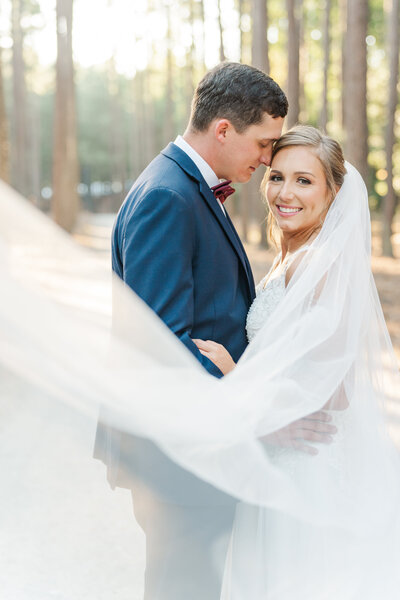 Newlyweds Mark and Emily underneath Carrigan Farms' willow tree captured by Charlotte NC wedding photographer