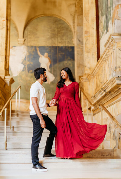 Man guides his fiance down grand staircase