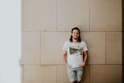 Man posing against wall