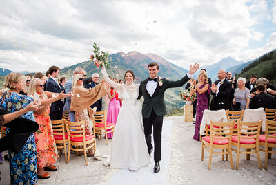 Couple walking with mountains in the background at Crested Butte wedding