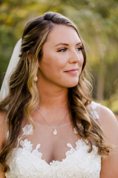 Bride with veil looking softly away wedding at barn at murphey farm