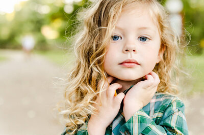 Close up of a toddler boy with long blonde hair captured by a family photographer near Chicago, IL.
