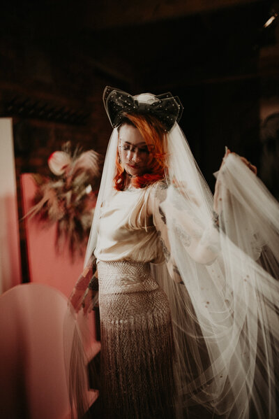 A tattooed bride spins around to show off her dress at The Chimney House in Kelham Island, Sheffield. 