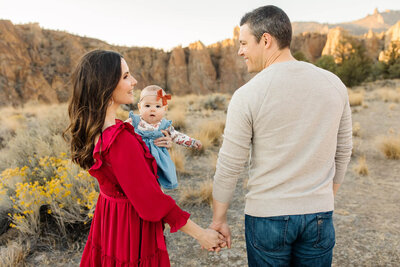 young mom and dad holding baby  at smith rock family photos