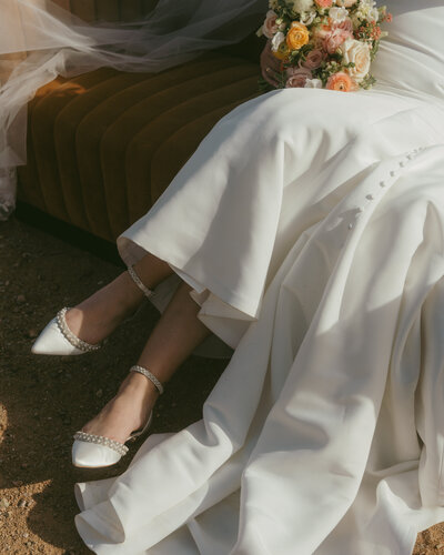 Boho elopement bouquet with dried florals and fresh blooms in front of the superstition mountains