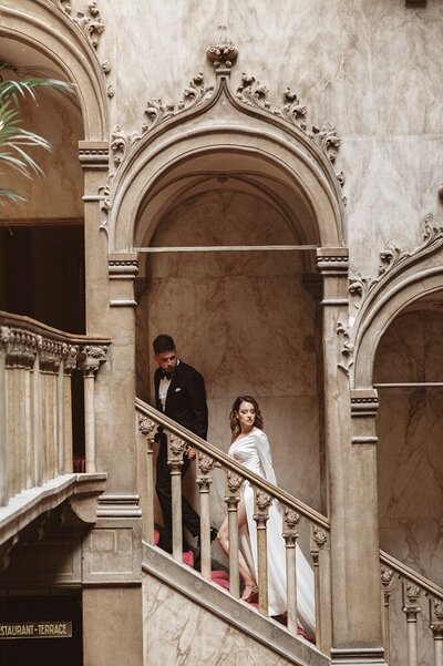 Bride and groom standing on the stairs in Venice, Italy. 