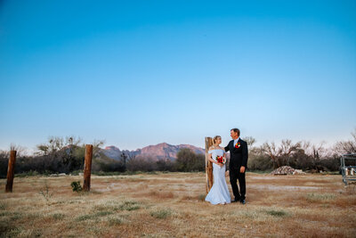 bride and groom pose in arizona mountains