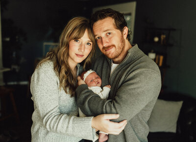 Newborn baby peacefully sleeping under a sheer blanket with a delicate white butterfly accents, captured in a soft and ethereal studio setup by Duehr Photography in Maple Grove,MN
