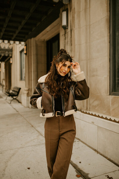 Oklahoma Photographer Michelle Albert standing in all brown fit in downtown okc