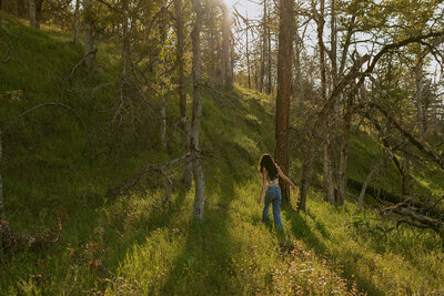 girl in white dress standing next to waterfall in columbia river gorge
