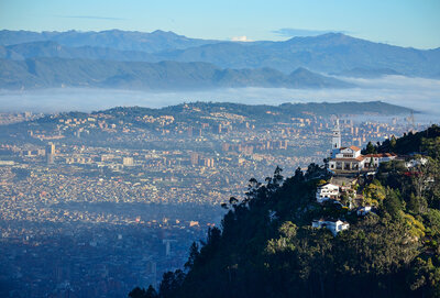 Monserrate Church on top of mountain surrounded by forest, city scape background, Bogota, Columbia