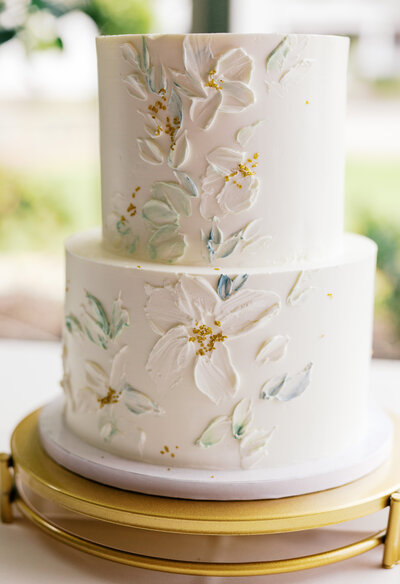Up close image of a wedding cake with flowers.
