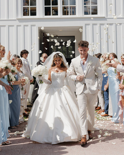 bride and groom walk out of the Chapel of Seaside