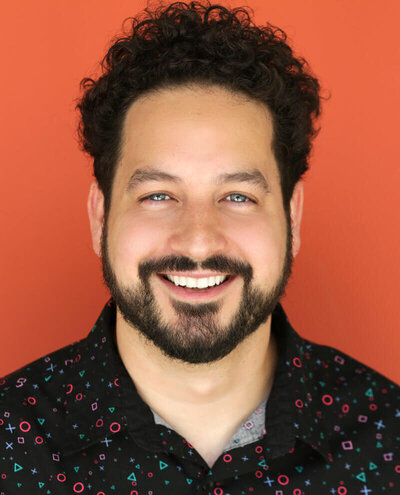 Headshot of Ahmed Bharoocha standing against an orange background