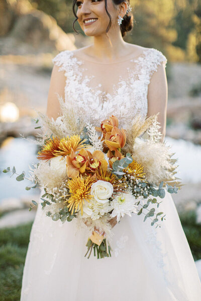 Bridal bouquet featuring earthy tones and airy pampas leaves