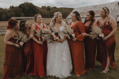 Bride laughing with bridesmaids at farm wedding in La Crosse, Wisconsin