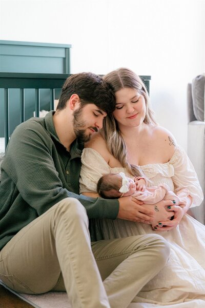 Couple on their front porch holding their baby