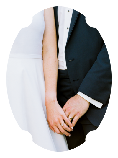 Close-up of a bride and groom holding hands