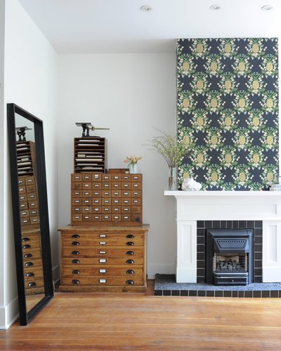 Pineapple wallpaper on fireplace mantel, vintage furniture piece storing jewelry materials & supplies