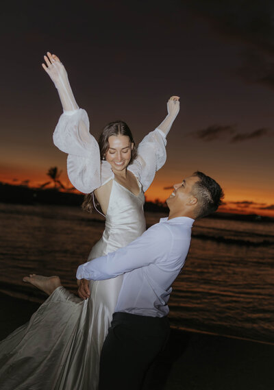 destination elopement photography  in Hawaii bride and groom laughing eloping on the beach