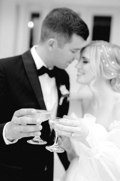 Couple cheersing champagne at Moore Mansion wedding