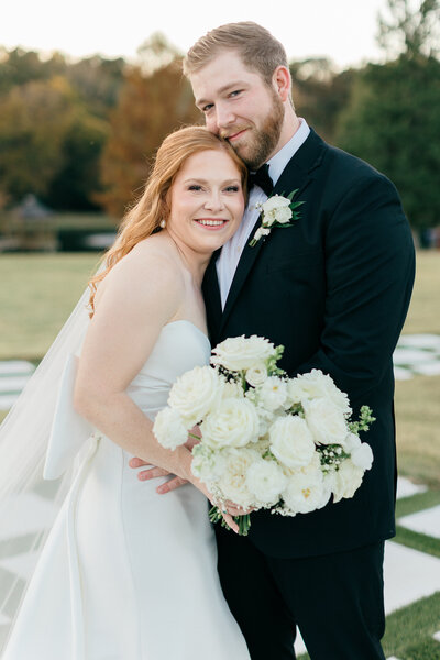 Bridal portraits on steps near a lake