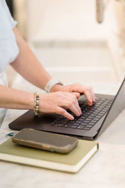 Dinah typing on her Macbook