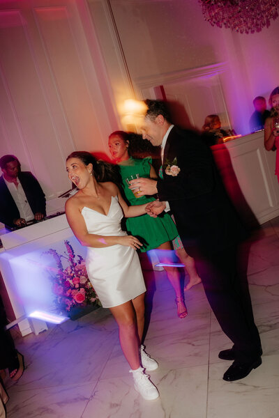a bride and groom dancing at their wedding reception with colorful lights photographed by alabama and washington wedding photographer sarah mismash