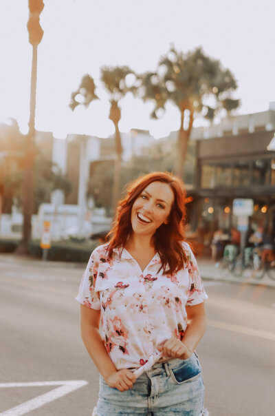 girl smiling at camera with city in background