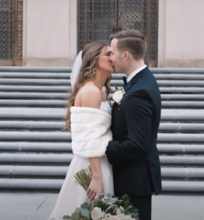 a bride and groom kissing outside the Scottish Rite Cathedral