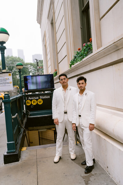 couple leaning against a subway sign