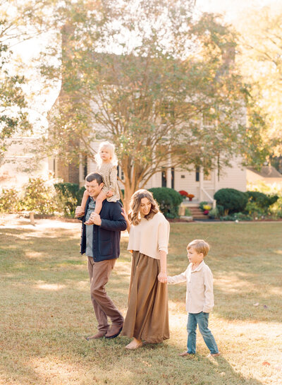 Family walking during their family portrait session in Wake Forest, NC. Photographed by Raleigh family photographer A.J. Dunlap Photography.
