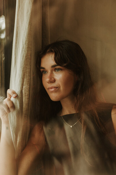 Brisbane photographer capturing a quiet, reflective moment during a branding session, filled with warmth and softness.