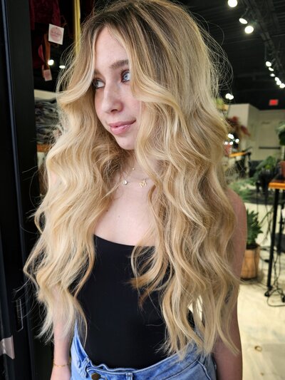 Maddie showing off 22" long blonde extensions installed and maintained by Moxie by KC