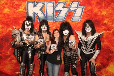 Brittany Hodak, Zinepak Cofounder, posing with the band KISS.