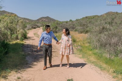 Engaged couple walk a trail in James Dilley Preserve in Laguna Beach