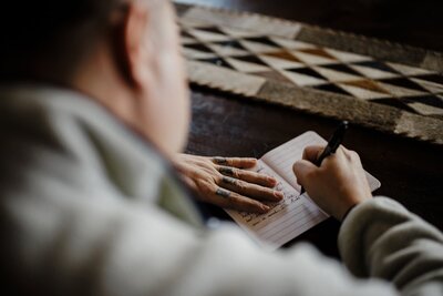 Groom writes his vows before elopement ceremony.