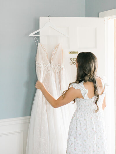 bride looking at her wedding dress and getting ready for the ceremony