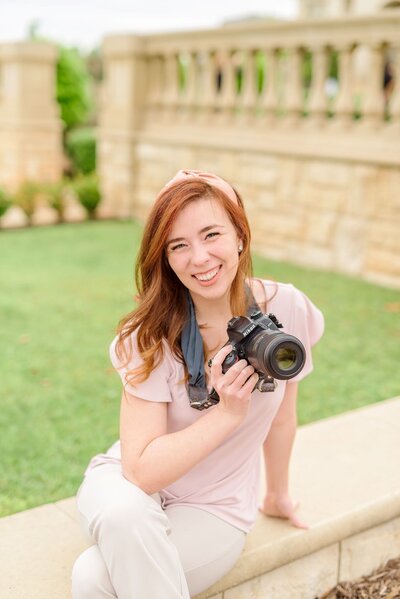 A girl holding a camera offers wedding photography in Raleigh, North Carolina.