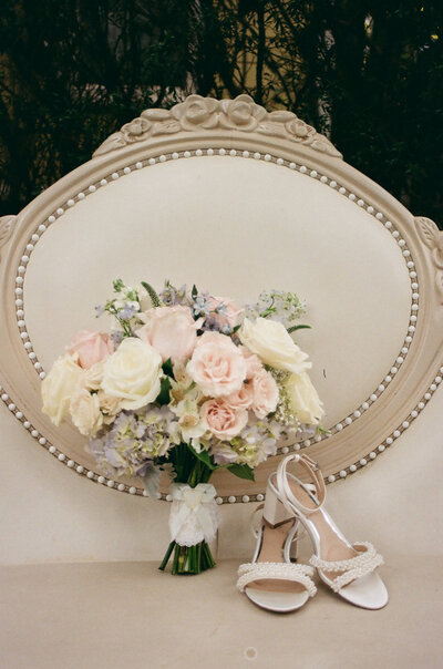 bride holding white and blush wedding bouquet
