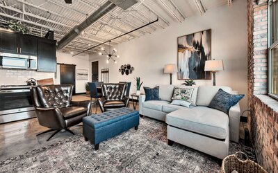 Ample seating in the living room of this one-bedroom, one-bathroom rental condo in the historic Behrens building just blocks from the Magnolia Silos and Baylor University in downtown Waco, TX.