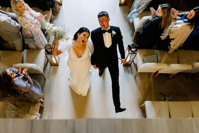 a wedding couple pulling a silly face as they exit the ceremony room at Wharfedale Grange