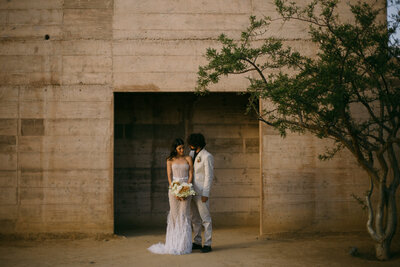 Couple at the entrance of luxury hotel Paradero in Todos Santos, Mexico during their elopement.