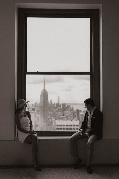 engaged-couple-in-front-of-city-view