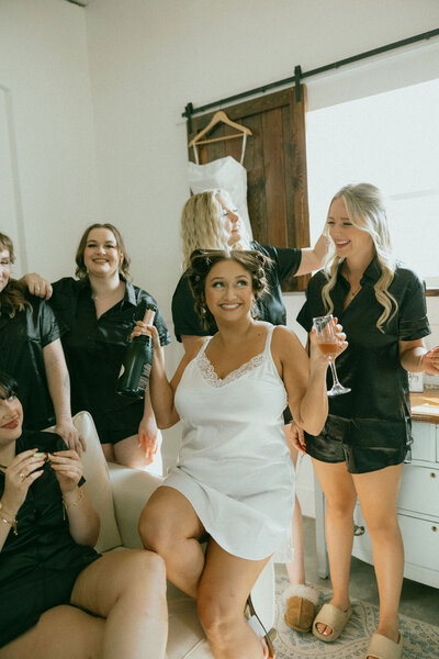 Bride holds a glass of champagne