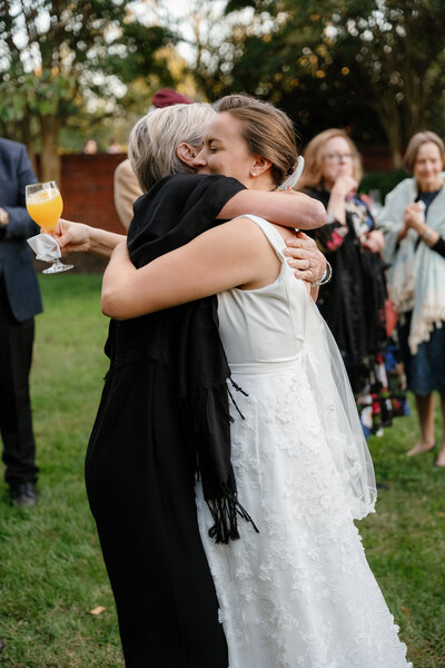 Wedding guests holding someone up on the dance floor