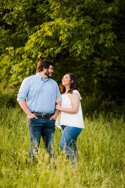 Man and woman looking at each other for engagement photo at a Nashville farm. 