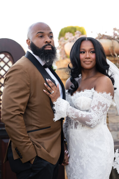 A bride wearing Pnina Tornai poses with her groom on wedding day