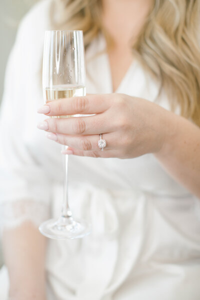 Bride Holding Champagne in Left Hand with Engagement Ring