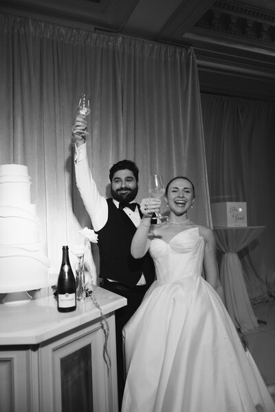 a bride and groom laughing at their wedding reception captured by Southern California documentary wedding photographer.